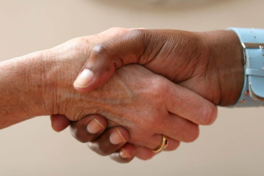 Close up image of two people shaking hands.